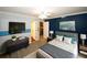 Comfortable bedroom with a ceiling fan, a TV and neutral decor at 711 Cypress Pointe St, Johns Creek, GA 30022