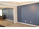 Bedroom featuring carpet and blue accent wall, with a mirror door closet at 711 Cypress Pointe St, Johns Creek, GA 30022