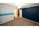 Bedroom featuring plush carpet, a ceiling fan, and large blue accent wall at 711 Cypress Pointe St, Johns Creek, GA 30022