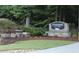 Stone sign for Rivermont The Park community welcomes residents and visitors with landscaping at 711 Cypress Pointe St, Johns Creek, GA 30022