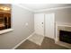 Home entryway featuring neutral paint, a fireplace and access to the kitchen at 711 Cypress Pointe St, Johns Creek, GA 30022