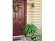 Charming front door with a seasonal wreath and a lovely potted fern at 711 Cypress Pointe St, Johns Creek, GA 30022