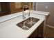 Modern kitchen sink with stainless steel fixtures and white countertops provides an eye-catching appeal at 711 Cypress Pointe St, Johns Creek, GA 30022
