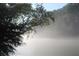 Scenic lake view shrouded in a light fog, creating a serene and peaceful setting at 711 Cypress Pointe St, Johns Creek, GA 30022