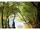 Picturesque lake view through lush foliage, perfect for nature lovers at 711 Cypress Pointe St, Johns Creek, GA 30022