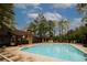 Large swimming pool surrounded by lounge chairs and greenery at 711 Cypress Pointe St, Johns Creek, GA 30022