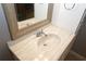 Bathroom vanity featuring a decorative mirror, modern faucet, and a marble countertop at 711 Cypress Pointe St, Johns Creek, GA 30022