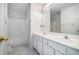 Bright bathroom with dual sink vanity and shower over tub with white tile at 750 Beckenham Walk Dr, Dacula, GA 30019