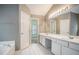 Bathroom featuring double sink vanity, tile floor and separate bathtub at 750 Beckenham Walk Dr, Dacula, GA 30019