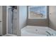 Bathroom with a soaking tub and a glass shower at 750 Beckenham Walk Dr, Dacula, GA 30019