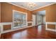 Traditional dining room featuring wainscoting, beautiful chandelier, hardwood floors, and a large window filling the space with light at 750 Beckenham Walk Dr, Dacula, GA 30019