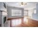 Sunlit living room featuring hardwood floors, a cozy fireplace, and large windows overlooking a great view at 750 Beckenham Walk Dr, Dacula, GA 30019