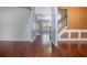 Inviting living room with hardwood floors, and neutral paint, seamlessly blending elegance and comfort with stair access nearby at 750 Beckenham Walk Dr, Dacula, GA 30019