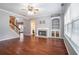Bright living room with hardwood floors, fireplace, built in shelving, crown molding, and staircase to the left at 750 Beckenham Walk Dr, Dacula, GA 30019