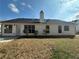 A view of the home's rear exterior, featuring large windows and a well-maintained lawn at 275 Circle Rd, Dacula, GA 30019