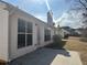 View of the home's backyard and exterior, featuring a clean white siding and brick chimney at 275 Circle Rd, Dacula, GA 30019