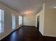 Dining area featuring dark laminate floors, a chandelier and direct access to the backyard at 275 Circle Rd, Dacula, GA 30019