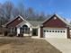 Charming single-story home featuring a brick facade, attached garage, and well-maintained landscaping at 275 Circle Rd, Dacula, GA 30019