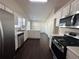 Well-equipped kitchen featuring stainless steel appliances, white cabinets, and dark laminate floors at 275 Circle Rd, Dacula, GA 30019