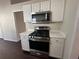 Kitchen featuring a stainless steel gas range and white countertops and cabinetry at 275 Circle Rd, Dacula, GA 30019