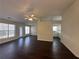 Bright living room featuring dark laminate floors, a ceiling fan and direct access to the kitchen at 275 Circle Rd, Dacula, GA 30019