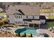 Overhead shot of a backyard with a pool, hot tub, patio with a covered area, and a fire pit area, highlighting the outdoor space at 330 Peninsula Pt, Canton, GA 30115