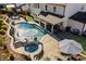 Aerial view of a backyard with a pool, hot tub, patio area, and covered outdoor seating, showcasing the outdoor living space at 330 Peninsula Pt, Canton, GA 30115