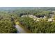 Overhead shot of lakefront home surrounded by dense foliage and overlooking calm lake waters at 330 Peninsula Pt, Canton, GA 30115