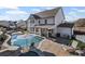 A stunning backyard featuring a luxurious pool, hot tub, and a covered patio with outdoor seating and barbecue grill at 330 Peninsula Pt, Canton, GA 30115