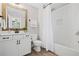 Bathroom with wood-look tile flooring, white cabinets, framed mirror, and shower with white subway tile surround at 330 Peninsula Pt, Canton, GA 30115