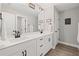 This modern bathroom boasts double sinks, black hardware, and a large mirror at 330 Peninsula Pt, Canton, GA 30115