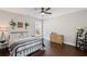 Bedroom features a ceiling fan, hardwood floors, and natural light at 330 Peninsula Pt, Canton, GA 30115
