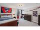 Bedroom with a sporty decor, including a bed, dresser, desk, and sports-themed decorations at 330 Peninsula Pt, Canton, GA 30115