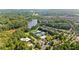 Aerial view of community clubhouse and amenities near the lake, surrounded by mature trees at 330 Peninsula Pt, Canton, GA 30115