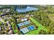 Aerial view of community tennis courts, pools, and clubhouse nestled among lush greenery at 330 Peninsula Pt, Canton, GA 30115