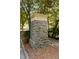 Stone entrance sign to 'The Peninsula' community, framed by trees and manicured greenery at 330 Peninsula Pt, Canton, GA 30115