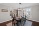 Bright dining room boasts dark wood table, modern lighting, a view to the foyer, and large window with wood shutters at 330 Peninsula Pt, Canton, GA 30115