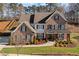 Stunning two-story brick home with a beautifully landscaped front yard and inviting covered porch at 330 Peninsula Pt, Canton, GA 30115