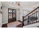 Elegant foyer with dark wood double doors, staircase, and hardwood flooring creates a warm and inviting entrance at 330 Peninsula Pt, Canton, GA 30115