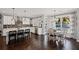 Open kitchen features white cabinets, stainless steel appliances, dark hardwood floors and an eat-in kitchen area at 330 Peninsula Pt, Canton, GA 30115