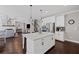 Open floor plan with kitchen island, white cabinets, stainless appliances and hardwood flooring at 330 Peninsula Pt, Canton, GA 30115