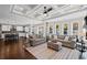 Open concept living room featuring a view to the kitchen, hardwood floors, neutral decor, and abundant natural light at 330 Peninsula Pt, Canton, GA 30115