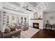 Spacious living room featuring a stone fireplace, coffered ceiling, hardwood floors, neutral decor, and abundant natural light at 330 Peninsula Pt, Canton, GA 30115
