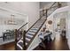 Elegant staircase with wrought iron railings leading to the upper level at 330 Peninsula Pt, Canton, GA 30115