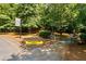 Entrance to walking trails, marked by a stone and wood pergola and a community sign at 330 Peninsula Pt, Canton, GA 30115