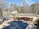 Aerial view of the pool, deck, backyard, gazebo, pool house, and landscaped surroundings at 444 Pineview Dr, Canton, GA 30114