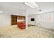 Spacious basement featuring built-in shelving, white walls, and neutral patterned carpet at 444 Pineview Dr, Canton, GA 30114