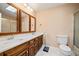 Bathroom vanity with double sinks, skylight, and framed mirrors at 444 Pineview Dr, Canton, GA 30114