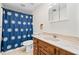 Bathroom featuring a vanity, toilet, and shower with a stylish blue patterned curtain at 444 Pineview Dr, Canton, GA 30114