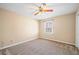 Bedroom featuring neutral carpet, fan, and a window for natural light at 444 Pineview Dr, Canton, GA 30114